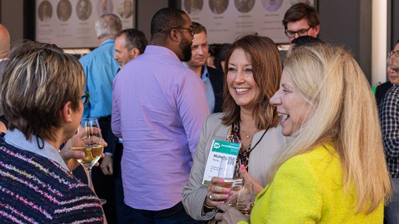 A group of people at a networking event smiling.