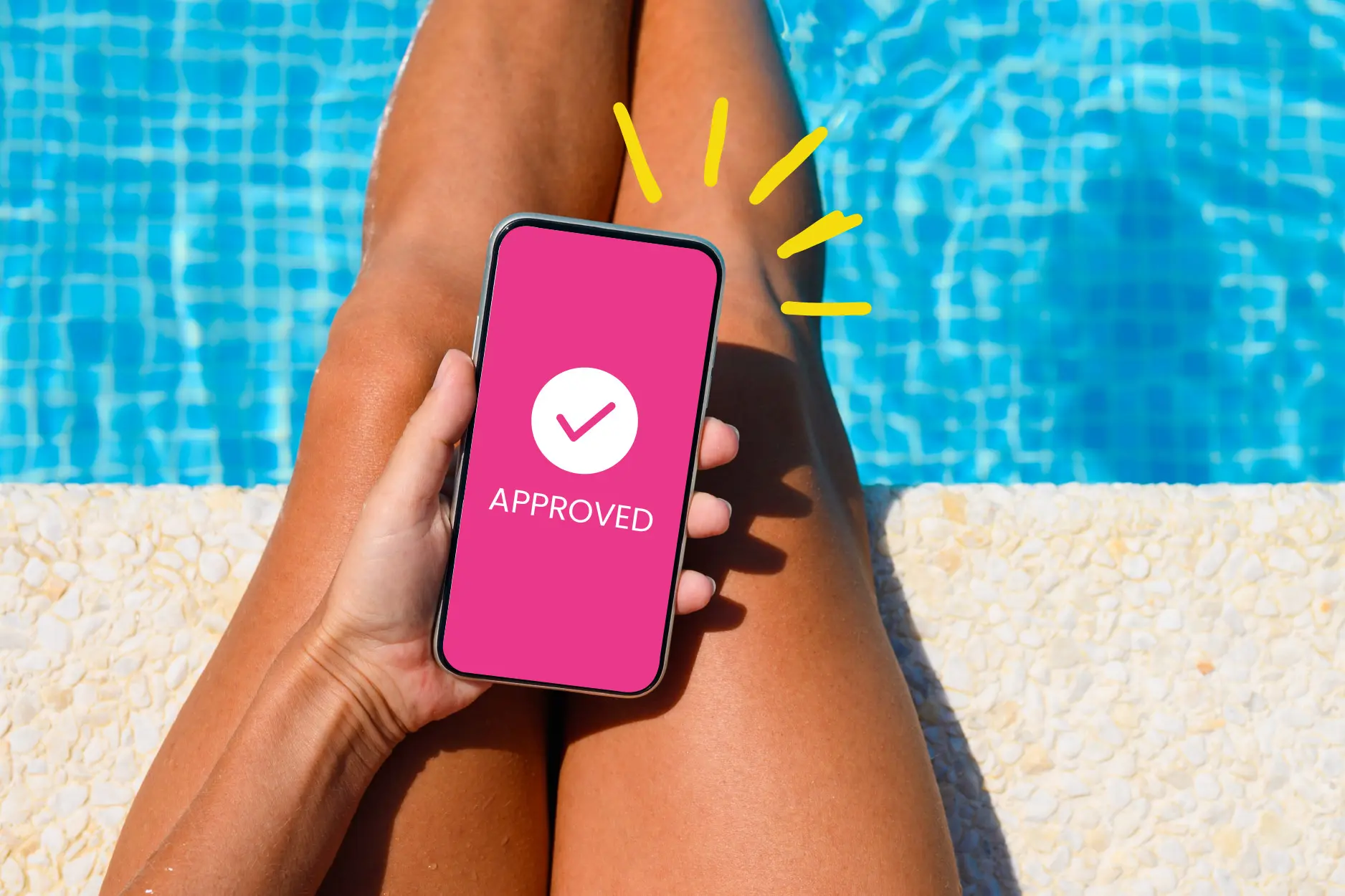 A person's hand holding a smartphone showing a pink "APPROVED" notification screen with a white checkmark. The background shows the person lounging by a bright blue swimming pool on a sunny day.